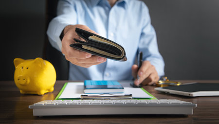 Businessman holding dollars with wallet.