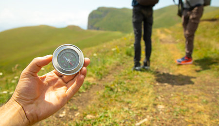 Traveler holding compass in nature background.の写真素材