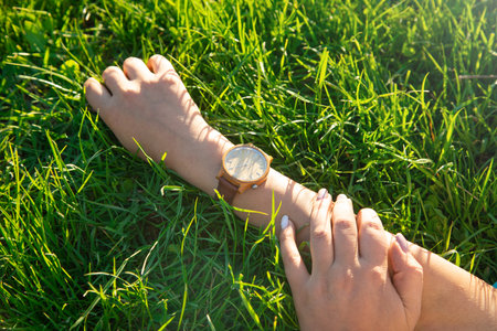 Caucasian girl with a wristwatch in hand.