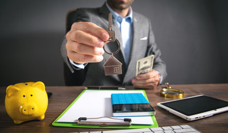 Real estate agent holding house key.
