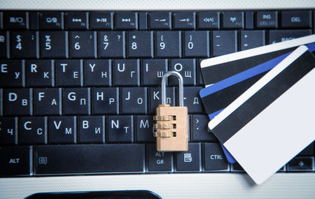 Padlock and credit cards on the computer keyboard. credit card security