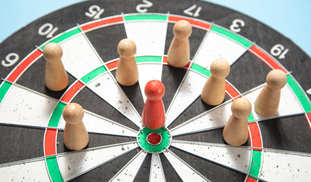 Wooden human figures on target dartboard. target. success. businessの写真素材