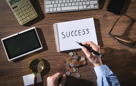 Man writes text Success in notepad.