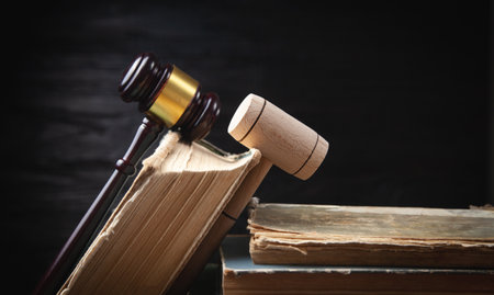 Judge gavel and book on the black background.