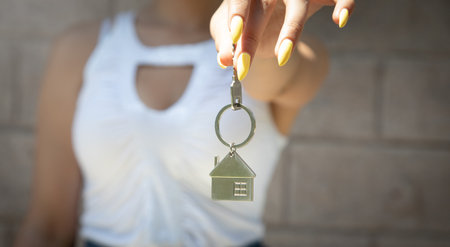 Woman holding house keys. real estate