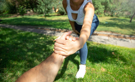 Male and female hands helping each other.