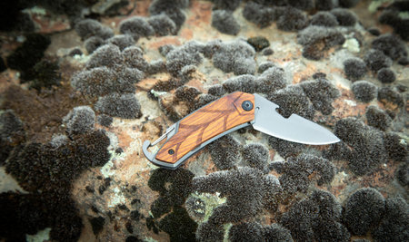 Knife on outdoor stone texture or background.