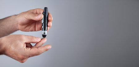 Man using lancet on finger. Checking blood sugar levels