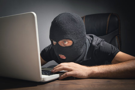 Hacker stealing information from the office computer. Hacking, Criminal