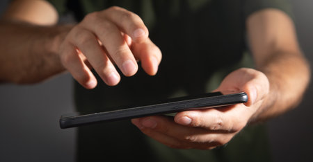 Caucasian man using smartphone at office.