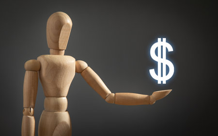 Wooden human figure showing dollar symbol.の写真素材