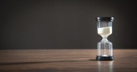Hourglass on the wooden desk.の写真素材