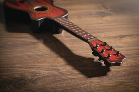 Guitar on the wooden background.