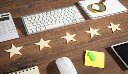 Wooden 5 stars with a business object on the table. Increase ratingの写真素材