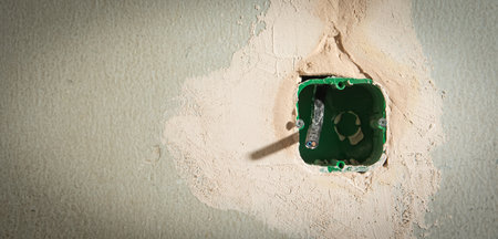 Wall with wire in socket holes. Preparation before installing socket