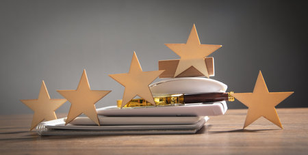 Wooden 5 stars with a business object on the table. Increase rating