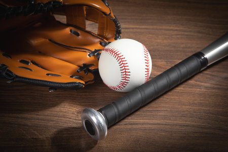 Leather glove with baseball and bat on the wooden background.の写真素材