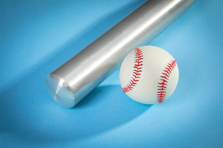 Baseball bat and baseball on the blue background.