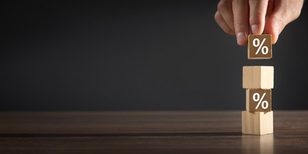 Man showing Percent symbol on wooden cube.の写真素材