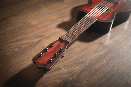Guitar on the wooden background.