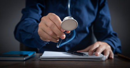 Caucasian man holding stethoscope at office.の写真素材
