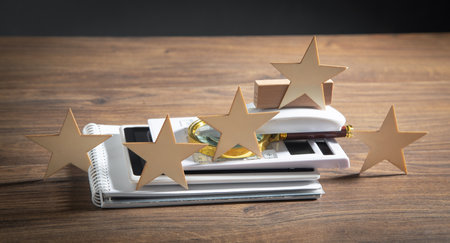 Wooden 5 stars with a business object on the table. Increase rating