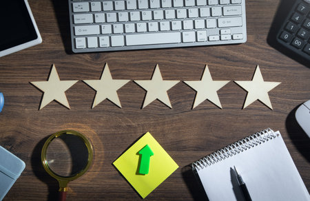 Wooden 5 stars with a business object on the table. Increase rating