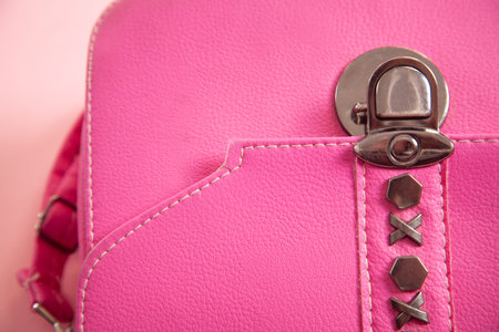 Detail of pink leather handbag on pink background.の写真素材