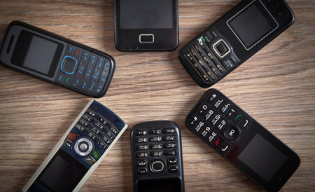 Old cell phones on wooden background.の写真素材