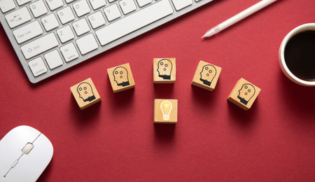 Light bulb and human heads on wooden cubes. Idea. Innovation. Teamwork
