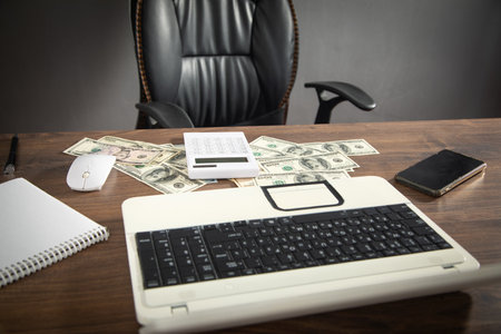 Computer mouse, calculator, money and computer keyboard.の写真素材