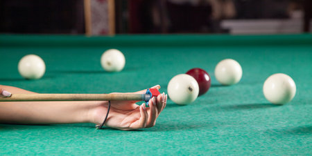 Caucasian young girl playing billiards.の写真素材