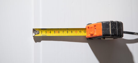 Measure tape on ceiling plastic panel.の写真素材