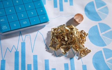 Golden jewelry on financial graphs.の写真素材