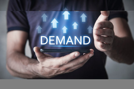 Male hand showing growing arrows and inscription Demand. Businessの写真素材