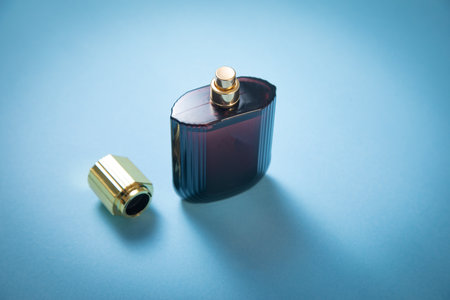 Bottle of perfume on the blue background.の写真素材