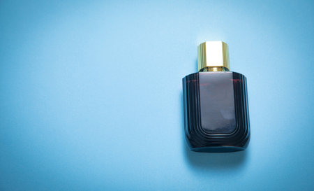 Bottle of perfume on the blue background.の写真素材