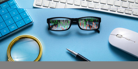 Stock market statistics on eyeglasses. Forex trading analysisの写真素材