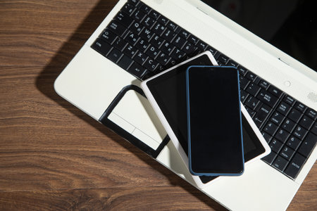 Smartphone, tablet, laptop computer on the wooden table.の写真素材