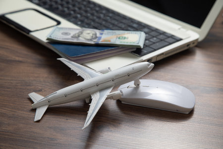 Toy airplane with a laptop computer.の写真素材