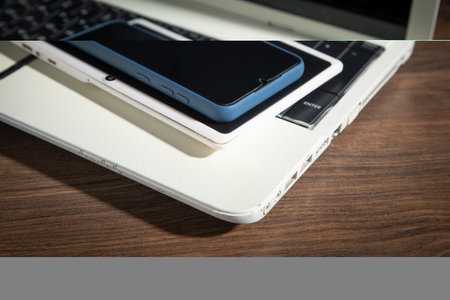 Smartphone, tablet, laptop computer on the wooden table.の写真素材