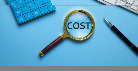 Magnifying glass with a word Cost and business objects. Businessの写真素材