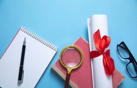 Diploma and business objects on the blue background.の写真素材