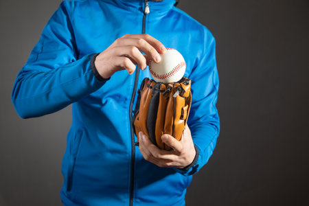 Man showing baseball ball and leather glove.の写真素材