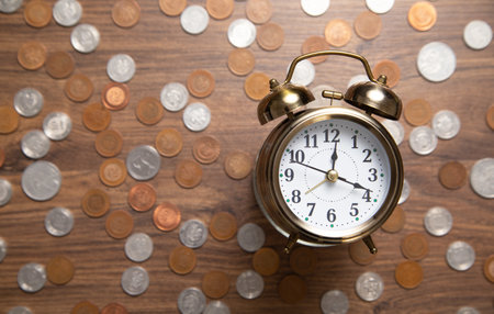 Clock and coins. Business concept