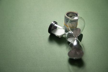 Hourglass with a dollar banknote. Business