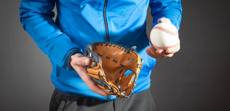 Man showing baseball ball and leather glove.の写真素材