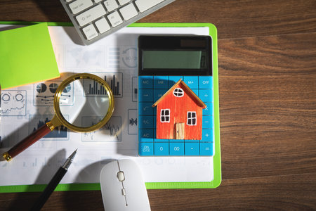 House model, graphs, magnifying glass with a business objects on the table.の写真素材