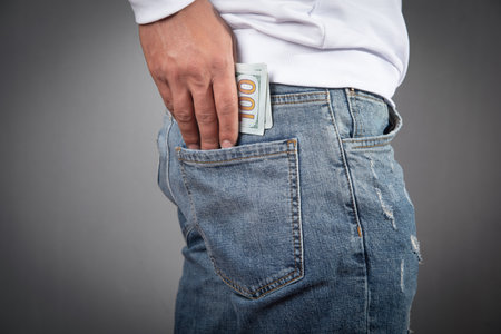 Man putting dollar into the pocket.の写真素材