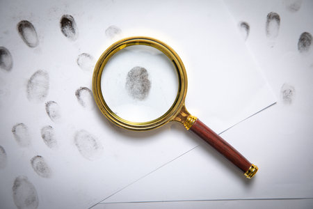 Magnifying glass and fingerprints. Detective. Investigationの写真素材